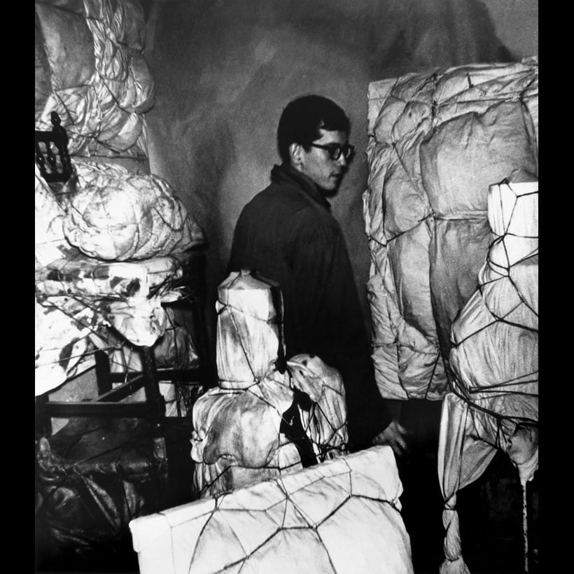 Inline Image - Christo in his seventh floor studio at 14, rue de Saint Sénoch, Paris, November 1961. Property of the Estate of Christo V. Javacheff. Image © Jean-Jacques Lévèque © 1961 Christo and Jeanne-Claude Foundation