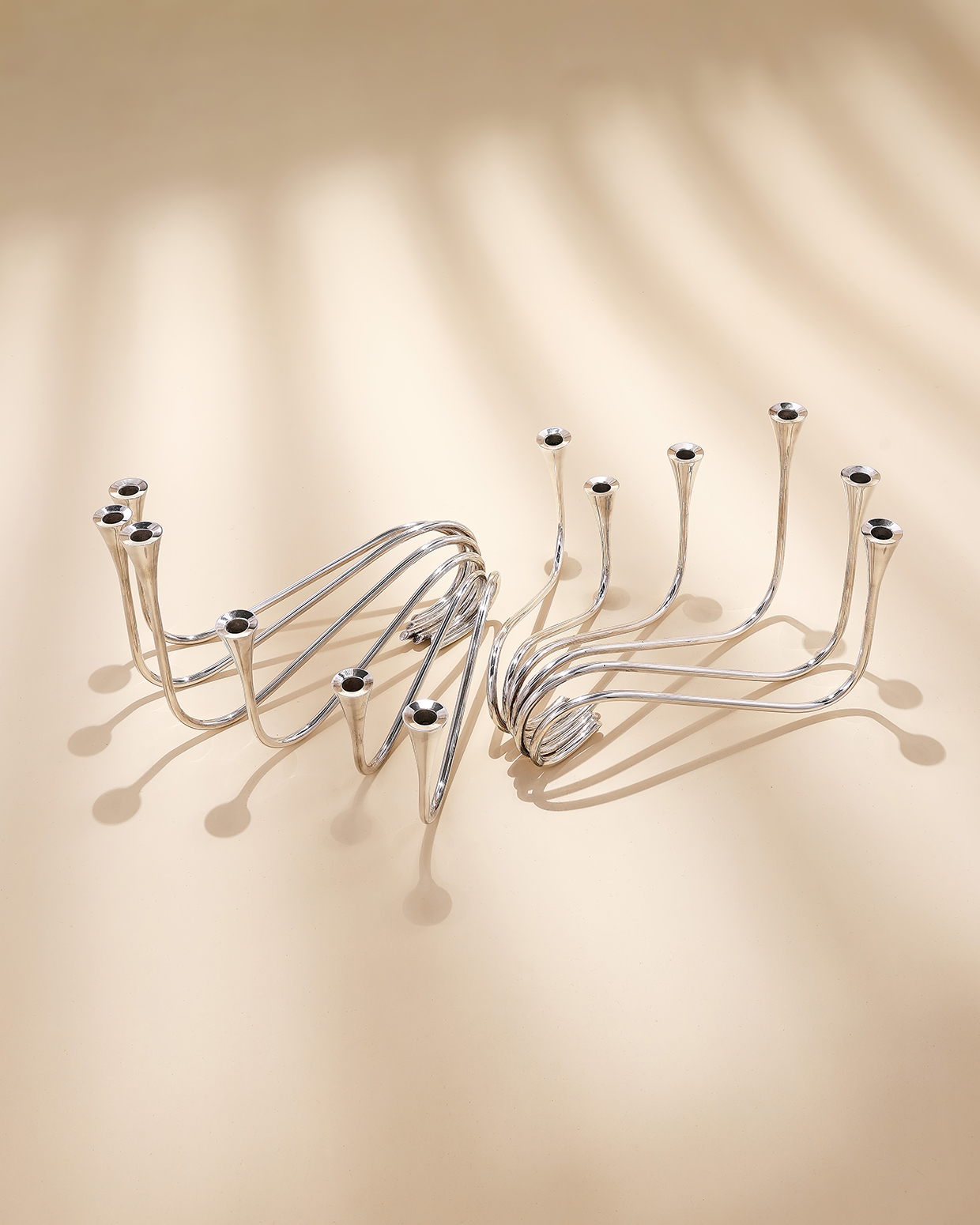 Inline Image - Lot 143: A pair of Danish silver wave pattern six branch candelabra, A. Michelsen, Copenhagen, sponsor's mark for R. C. P. Ltd., import mark for London 1954 | Est. £600-800 (+ fees)