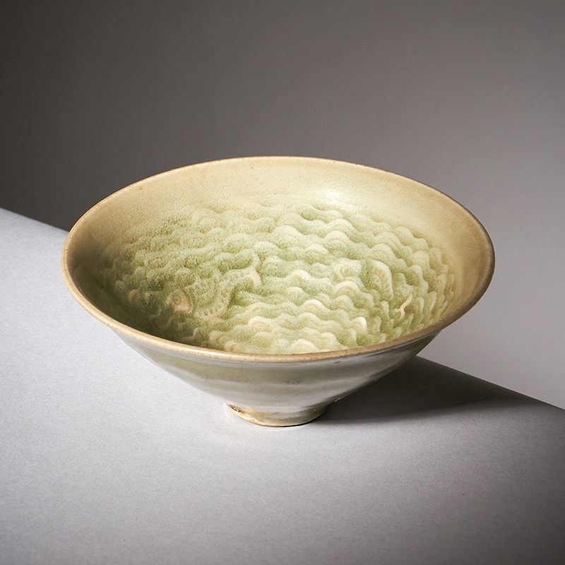 A rare small Chinese 'Yaozhou' celadon 'fish' conical bowl, Northern Song or Jin Dynasty, 12-13th century