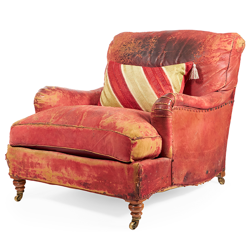 A late Victorian walnut and red leather armchair by Howard & Sons, late 19th/early 20th century