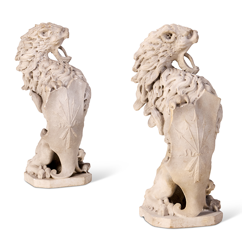A pair of early 19th century Italian carved marble heraldic or armorial lions