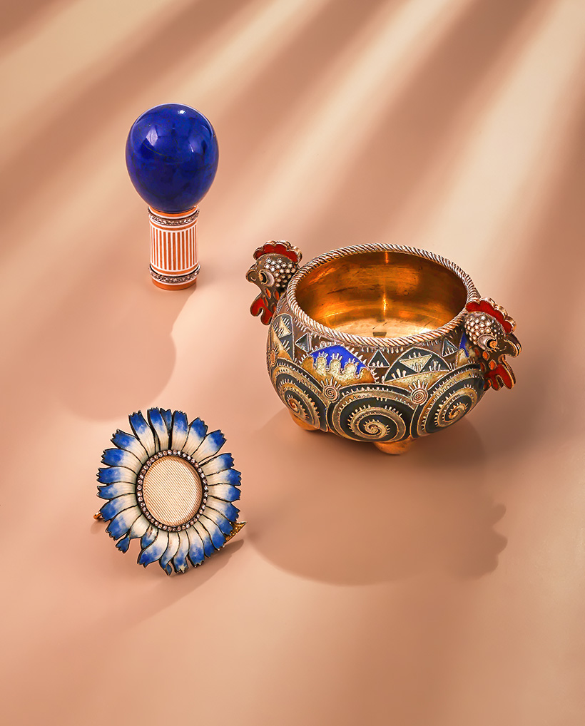 Inline Image - Top: Fabergé, a gold, lapis lazuli, diamond and enamel parasol handle workmaster Henrik Wigström, 1908-17 | Sold for £21,420. Centre: Fabergé, a silver gilt cloisonné enamel salt cellar, Moscow 1908-17 | Sold for £21,420. Bottom: Fabergé, a silver gilt, gold, enamel and diamond photograph frame, St. Petersburg 1899-1908 | Sold for £31,450