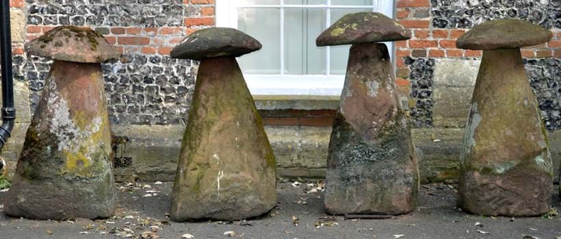 Inline Image - A group of four substantial rough hewn red sandstone staddle stones and caps; sold for £1,984