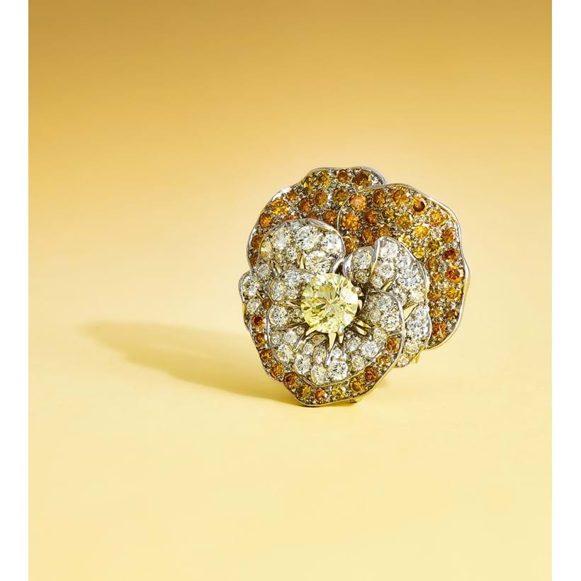 Inline Image - Oscar Heyman & Brothers, a coloured diamond and diamond 'Pansy' brooch circa 1966, centrally set with a brilliant cut Fancy yellow diamond, weighing 2.00 carats, the petals pavé set with brilliant cut diamonds and coloured diamonds | Sold at Dreweatts for £22,680