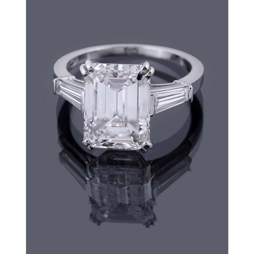 Inline Image - A single stone diamond ring by Van Cleef and Arpels, the step cut diamond with canted corners weighing 4.73 carats, E colour, VS1 clarity, four claw set above tapered baguette cut diamond shoulders, signed Van Cleef & Arpels | Sold at Dreweatts for £130,200