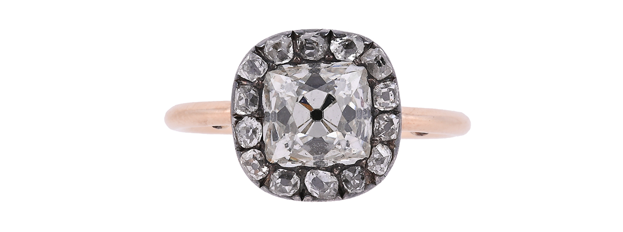A Georgian diamond cluster ring dated 1758, centrally set with an old mine cut diamond, approximately 2 carats.jpg