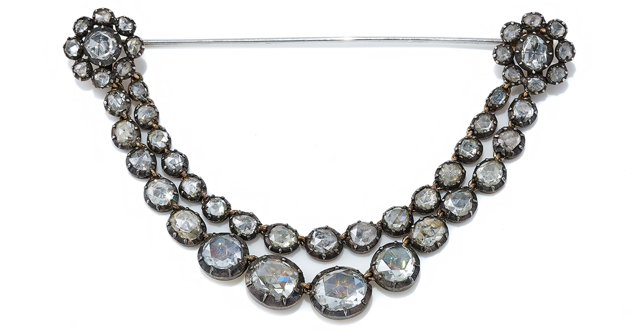 An antique diamond festoon brooch, early 19th century and later, composed of two graduated swags of foiled back rose cut diamonds.jpg