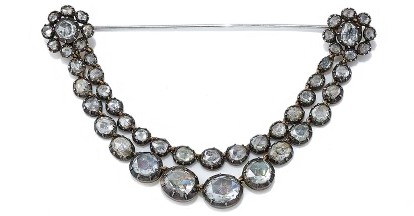 Inline Image - An antique diamond festoon brooch, early 19th century and later, composed of two graduated swags of foiled back rose cut diamonds | Sold at Dreweatts for £6,300