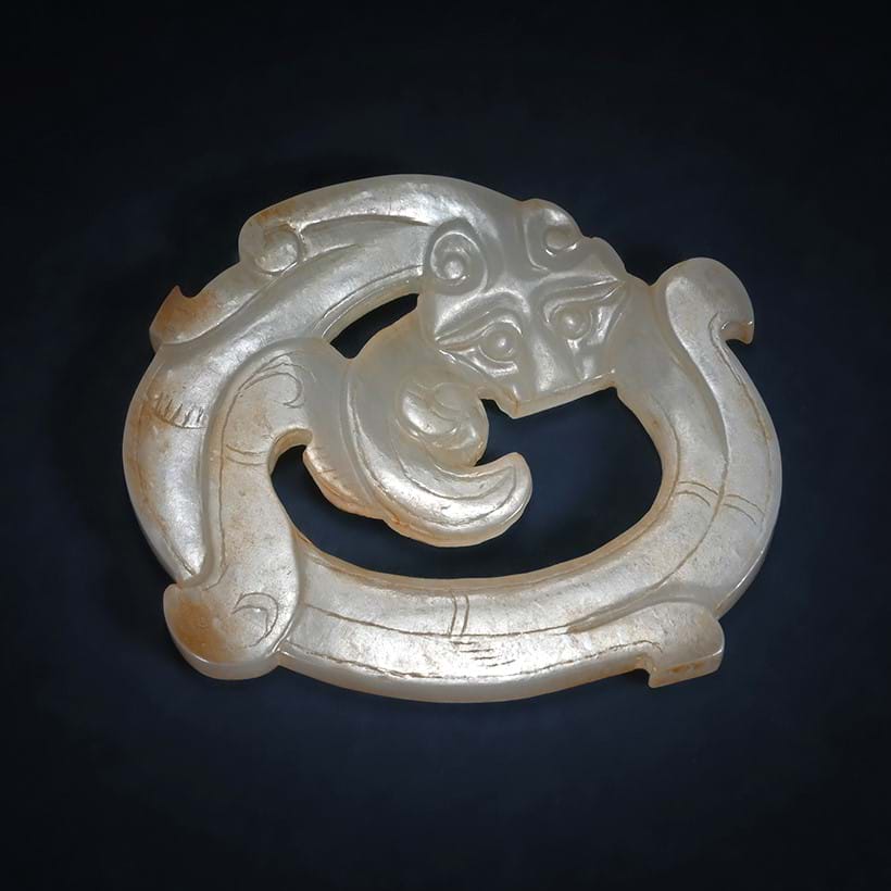 Inline Image - Lot 69: A Chinese carved white and russet jade 'Dragon' pendant, Han Dynasty (202BC-220AD) | Est. £5,000-8,000 (+ fees)