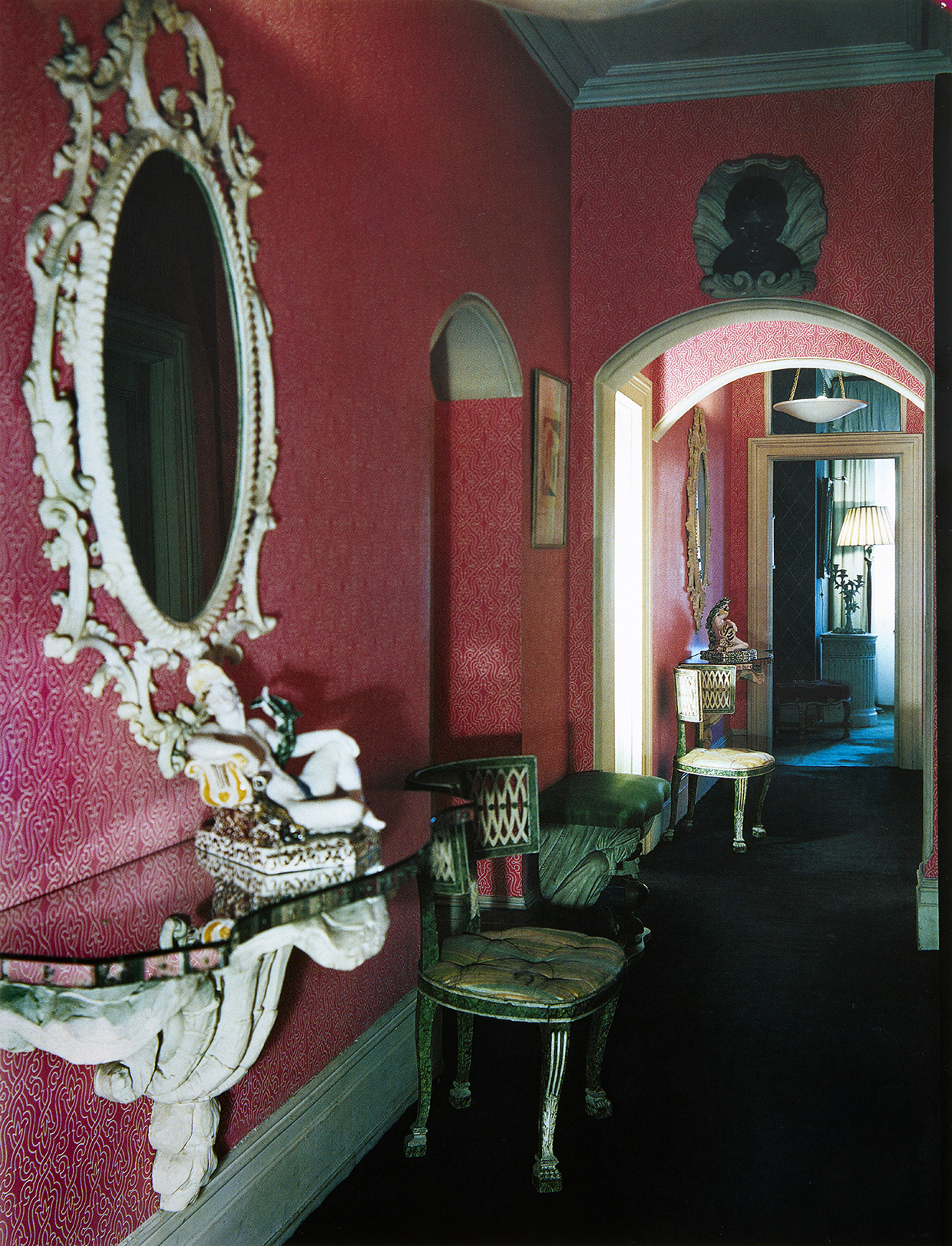 Inline Image - Park Lane entrance hall, treated in a Pseudo-Classical mode. The deep rose wallpaper was colour-matched to an Indian sari. Anthony Denney/ House and Garden, © Condé Nast Publications Ltd.