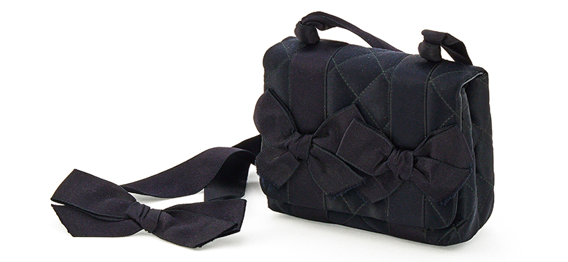 14810 Lot 304 Chanel a black satin bow mini bag, circa 1991-1994 Sold for £635.jpg