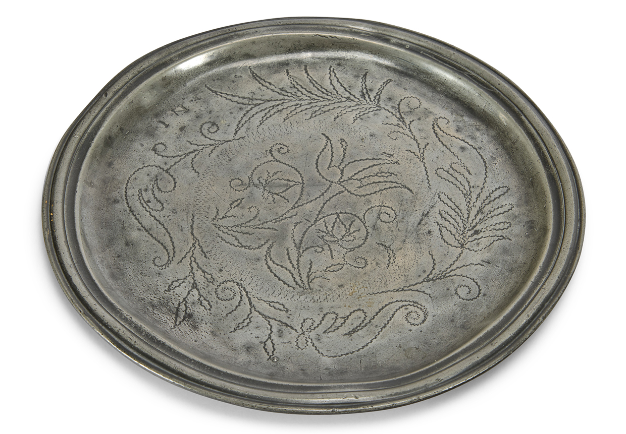 Lot 97 - a Queen Anne narrow rim wriggle work pewter plate from the Michael Eaton Collection.jpg