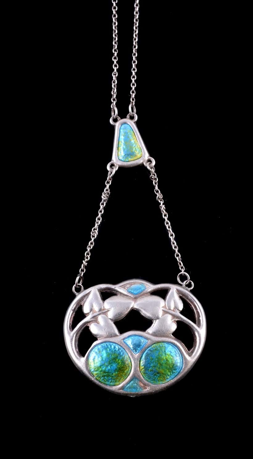 Inline Image - Lot 479, Arts & Crafts silver and enamel pendant by Charles Horner, Chester, 1909, the openwork foliate panel with green and blue enamel detail, with full Chester hallmarks, maker's mark CH, on a belcher chain; est. £80-120 (+fees)