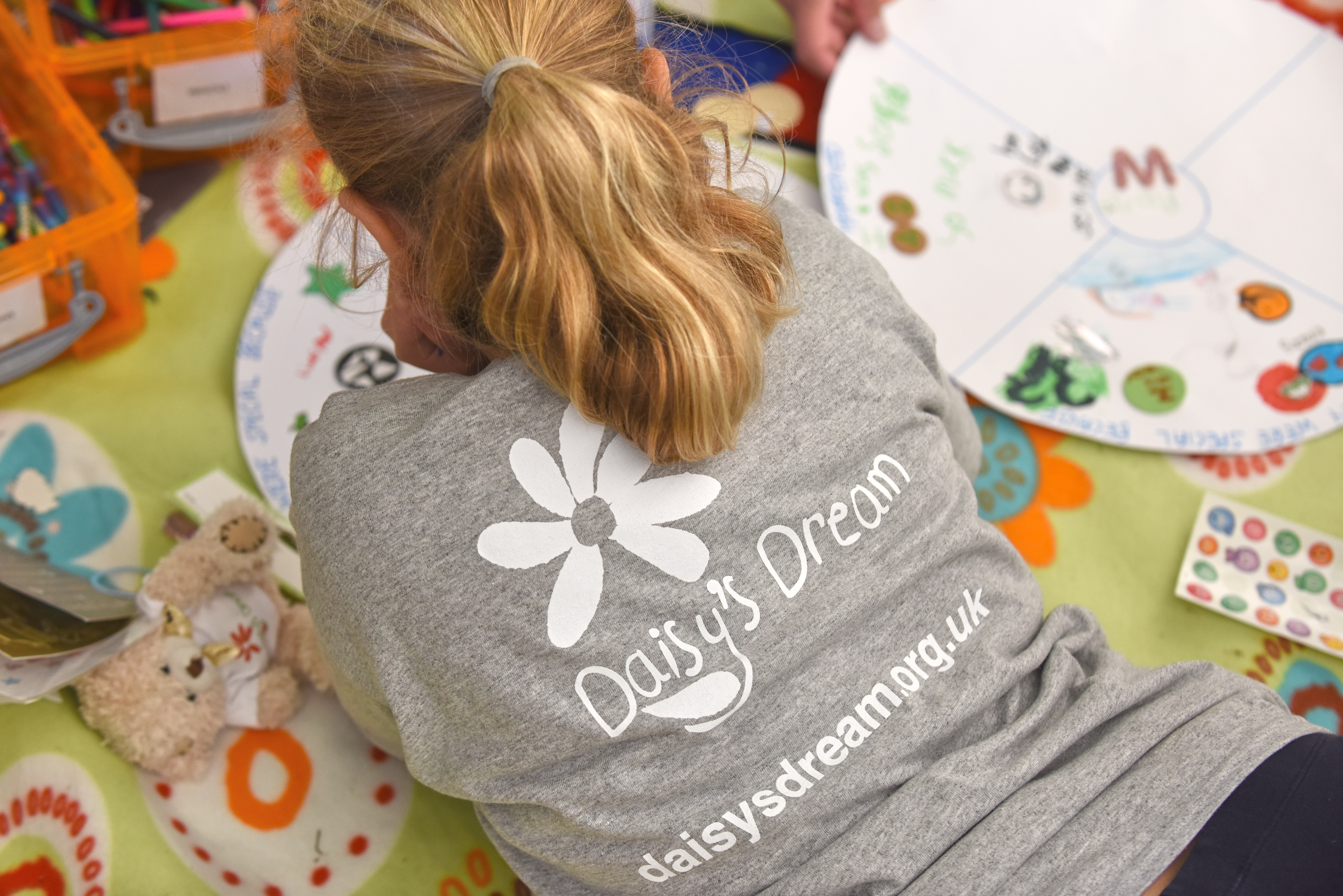 Back of DD girl lying down writing.jpg