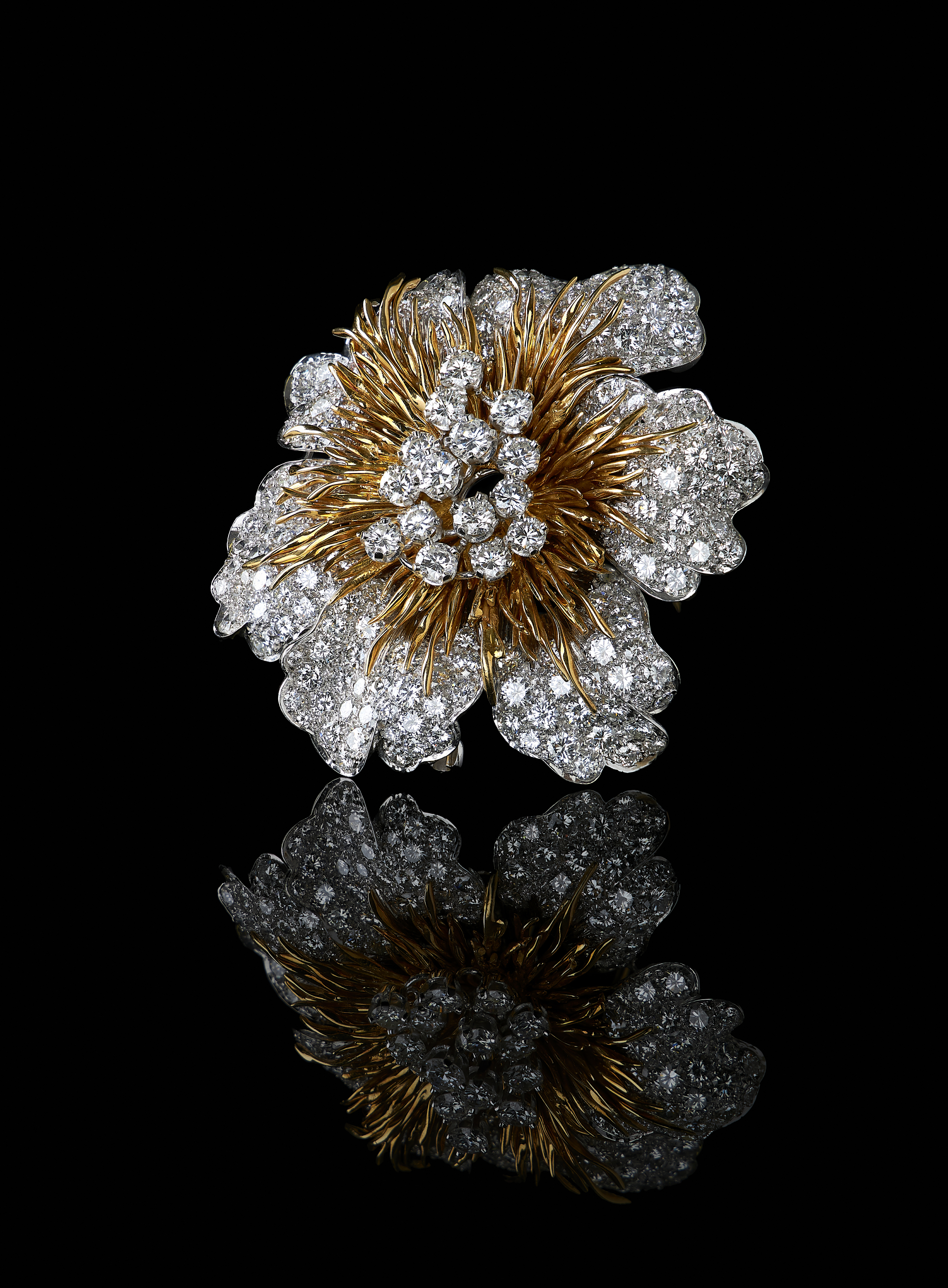Inline Image - Lot 206: A 1970s 18 carat gold and diamond flower head brooch by Kutchinsky | Est. £10,000-15,000 (+fees)