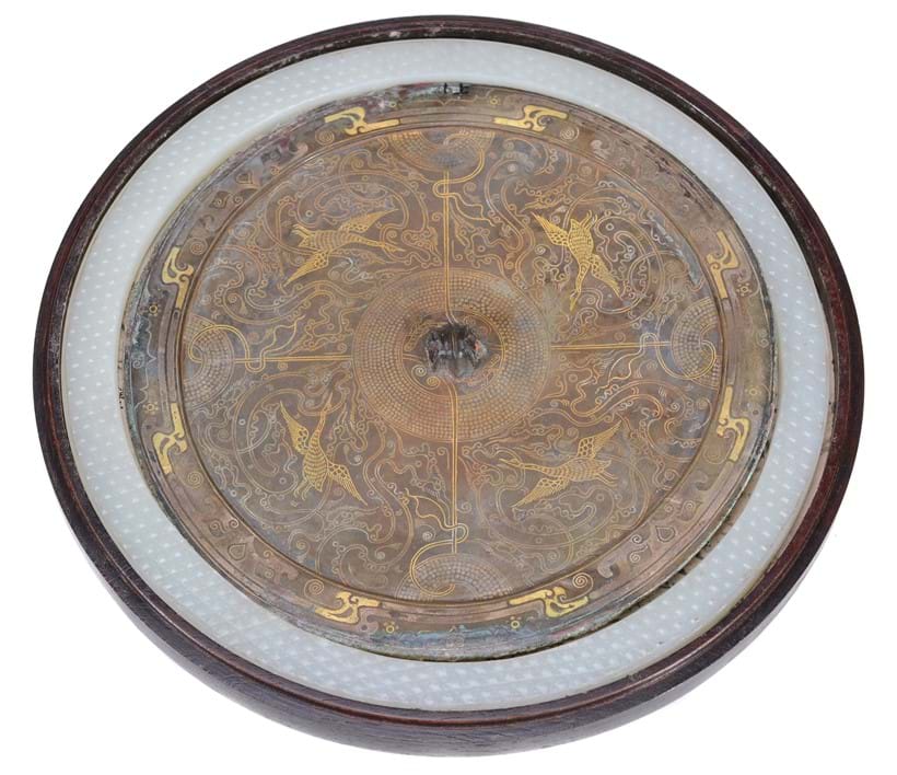Inline Image - Figure 1: (Part lot) A Chinese bronze Warring States style mirror, thinly cast, the central bamboo-shaped boss surrounded by images of cranes or geese, amidst anthropomorphic images | Sold for £5,000 (hammer price)
