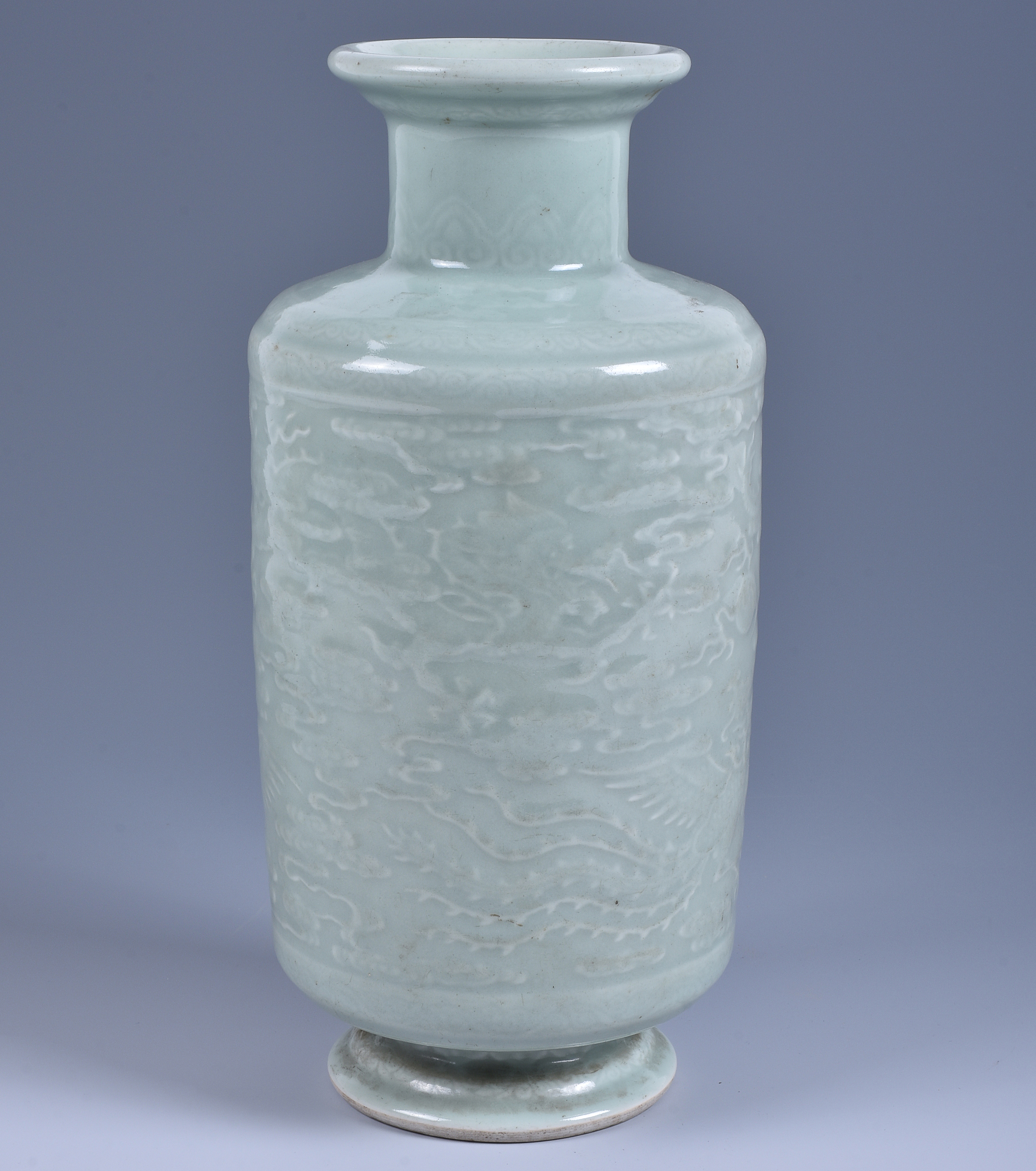 Inline Image - Figure 3: A Chinese celadon 'Dragon and Phoenix' vase, Yongzheng six-character mark, the cylindrical body supported on a slightly splayed base, the body delicately carved in relief with chilong confronting soaring phoenixes amid scrolling clouds | Sold for £290,000 (hammer price)
