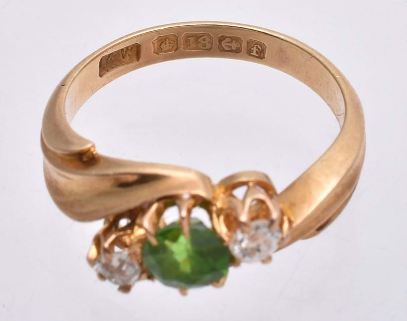 Inline Image - Hallmarks on an Edwardian demantoid garnet and diamond ring (Lot 237 12/8/20) which read: 18 carat gold (the crown and 18 punches), Birmingham Assay Office (The anchor punch) and the date letter f for 1905