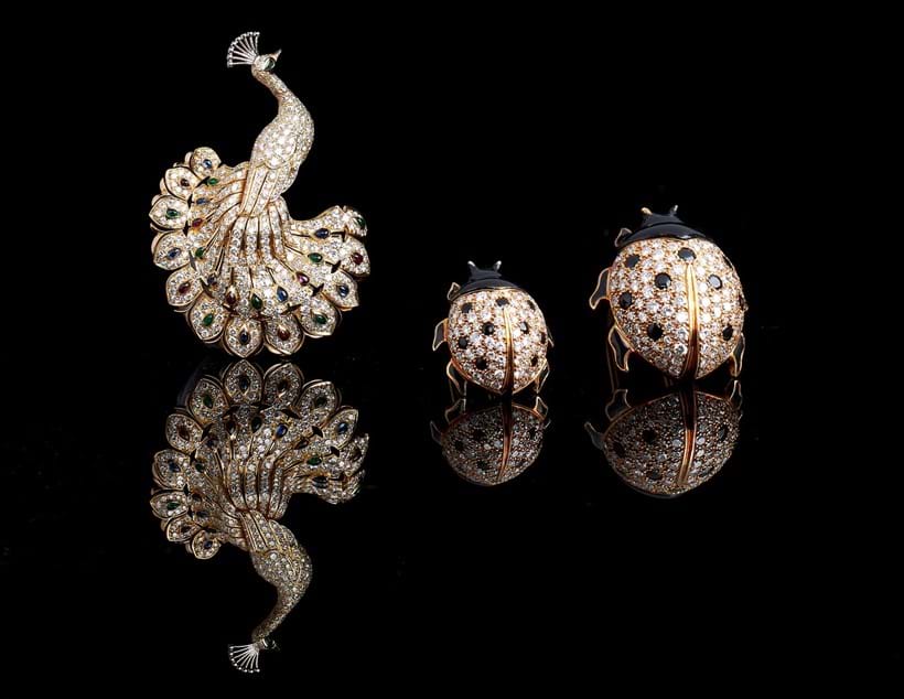 Inline Image - Lot 279, a diamond, sapphire, ruby and emerald peacock brooch by Cartier | Est. £12,000-18,000 (+fees); Lot 275, a pair of Coccinelle brooches by Cartier | Est. £6,000-8,000 (+fees)