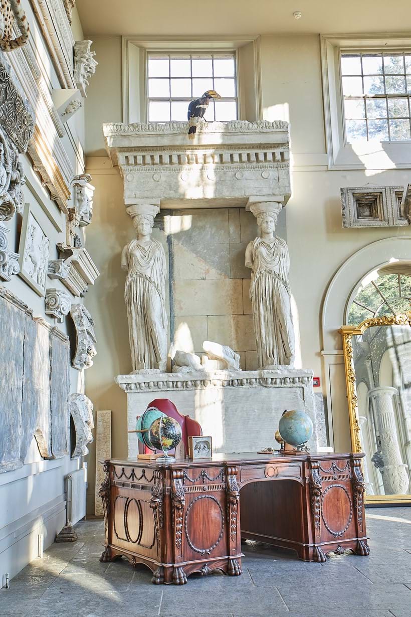 Inline Image - Lot 323: A MASSIVE PLASTER CAST OF A SECTION OF THE PORCH OF THE MAIDENS, FROM THE ERECHTEION, ATHENS, 20TH CENTURY, AFTER THE ANTIQUE, Showing two draped caryatids, supporting the entablature and raised on an egg-and-dart moulded plinth, The caryatids standing approximately 230cm tall, commensurate with the original marbles, base approximately 245cm wide | Est. £10,000-15,000 (+fees)