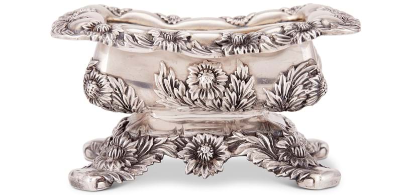 Inline Image - Lot 122: Tiffany, an American silver rounded rectangular Chrysanthemum pattern salt cellar by Tiffany & Co., stamped mark, no. 5720/501, Cook period 1902-07 | Est. £150-250 (+fees)