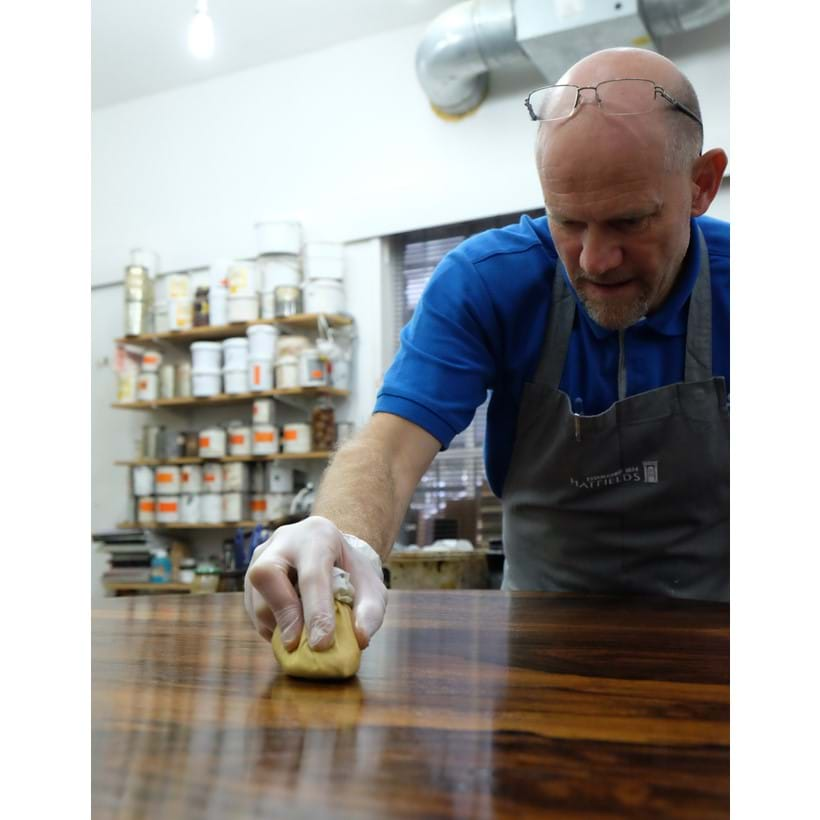 Inline Image - A Hatfields craftsman waxing a table top. Image courtesy of Hatfields Restoration