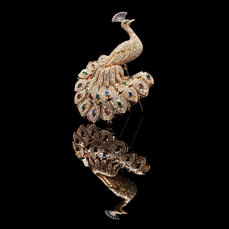 A diamond, sapphire, ruby and emerald peacock brooch by Cartier