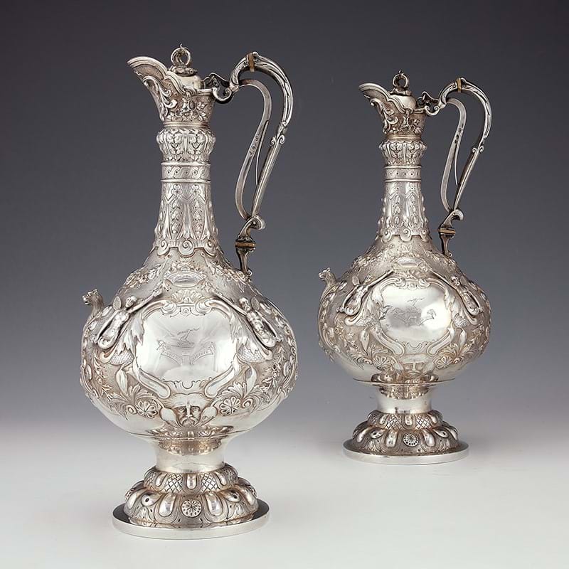 A pair of Victorian Irish silver Armada pattern claret jugs by John Smyth, Dublin 1879 and 1880