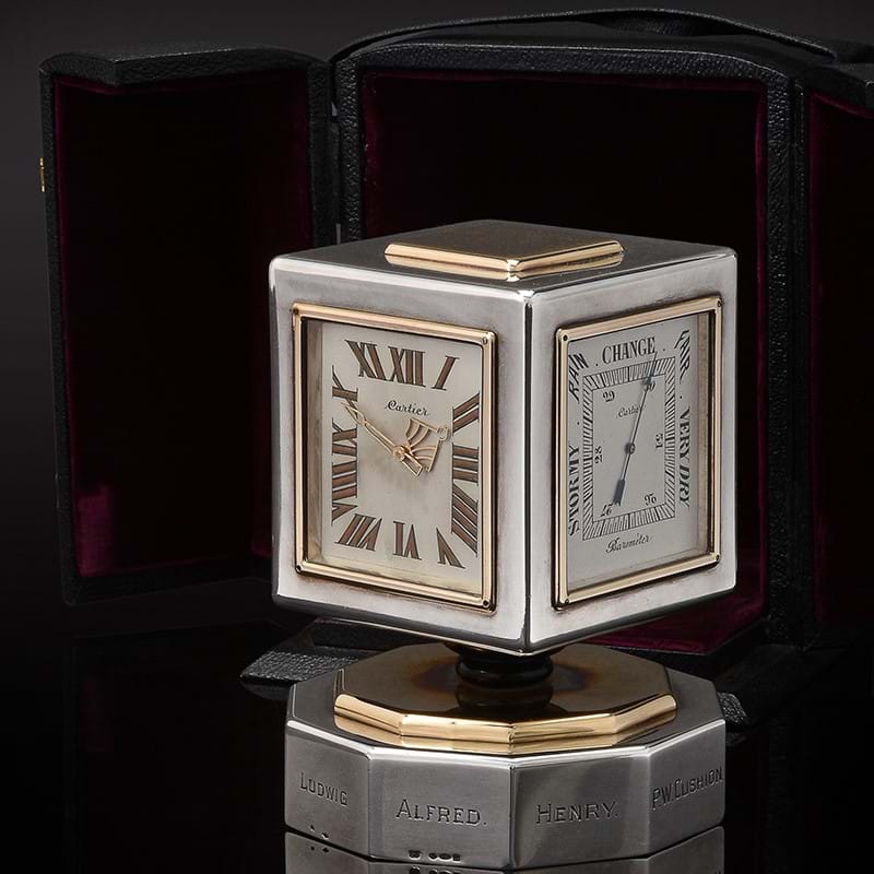 Cartier, a silver, gold and onyx mounted desk clock, perpetual calendar and weather station, import mark for London 1912