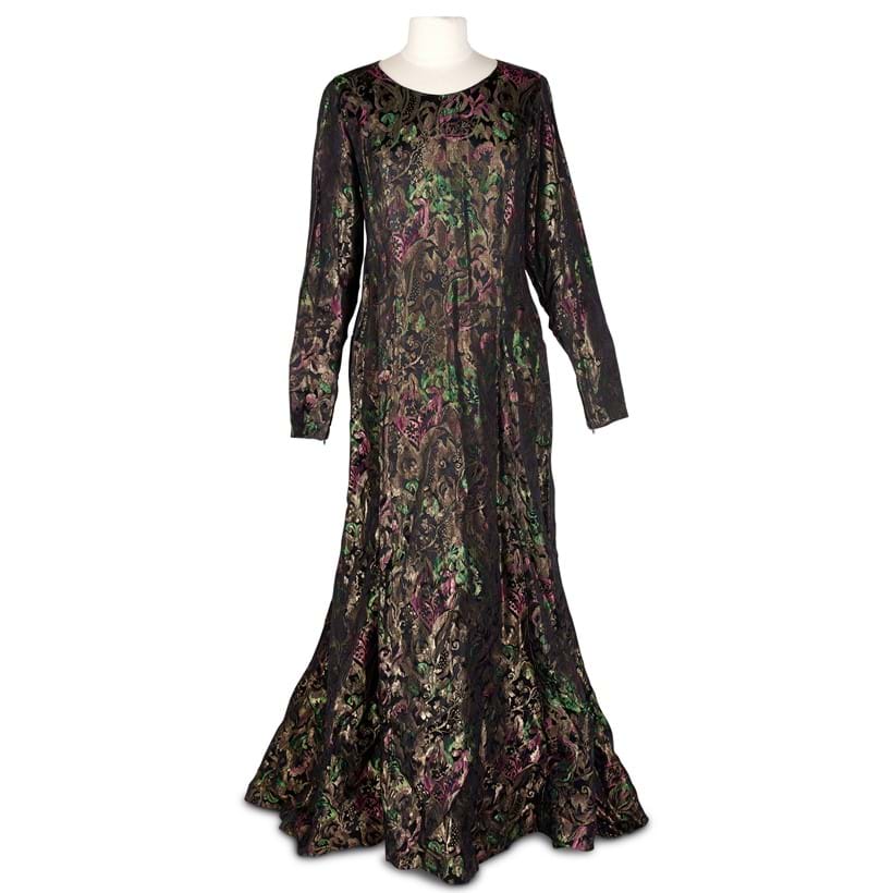 Inline Image - An evening dress in gilt metal brocade shot with emerald green and pink on a black ground,  mid 20th century | £80-100 (+ fees)