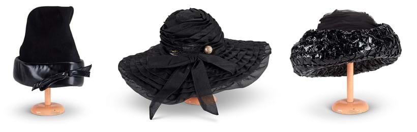 Inline Image - A tall black felt hat with wide glazed silk band and bow, with two 'pearl' hatpins, Est. £100-150 (+ fees) | A black broad-brimmed hat with a bow and hat pin, Est. £100-150 (+ fees) | A black glazed raffia and gauze hat with a turned-up rim and hat pin, Est. £100-150 (+ fees)