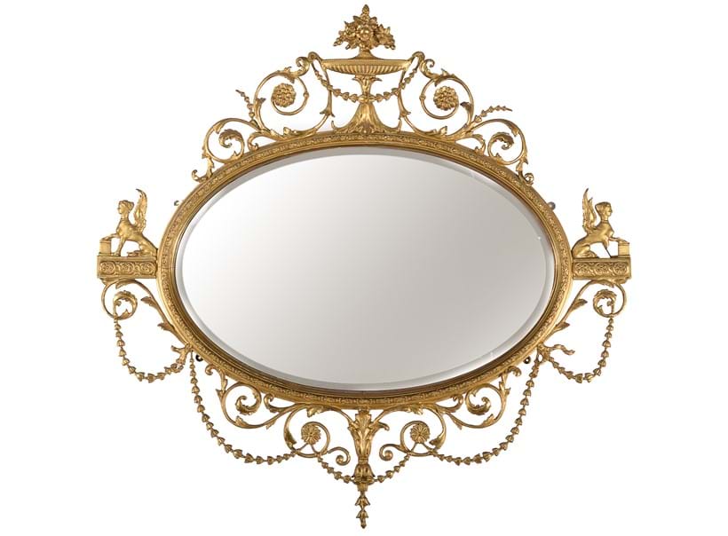 Inline Image - Lot 444: A giltwood and composition oval wall mirror, 20th century, after the manner of Robert Adam | Est. £1,000-1,500 (+ fees)