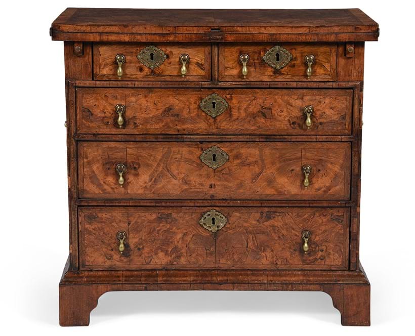 Inline Image - Lot 583: A George II figured walnut and feather banded bachelor's chest of drawers, circa 1730 | Est. £800-1,200 (+ fees)