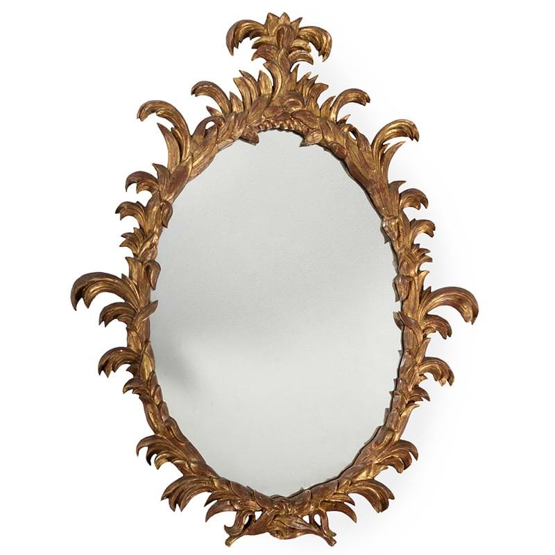 A carved giltwood oval wall mirror in George III style, 20th century, after the manner of Ince & Mayhew