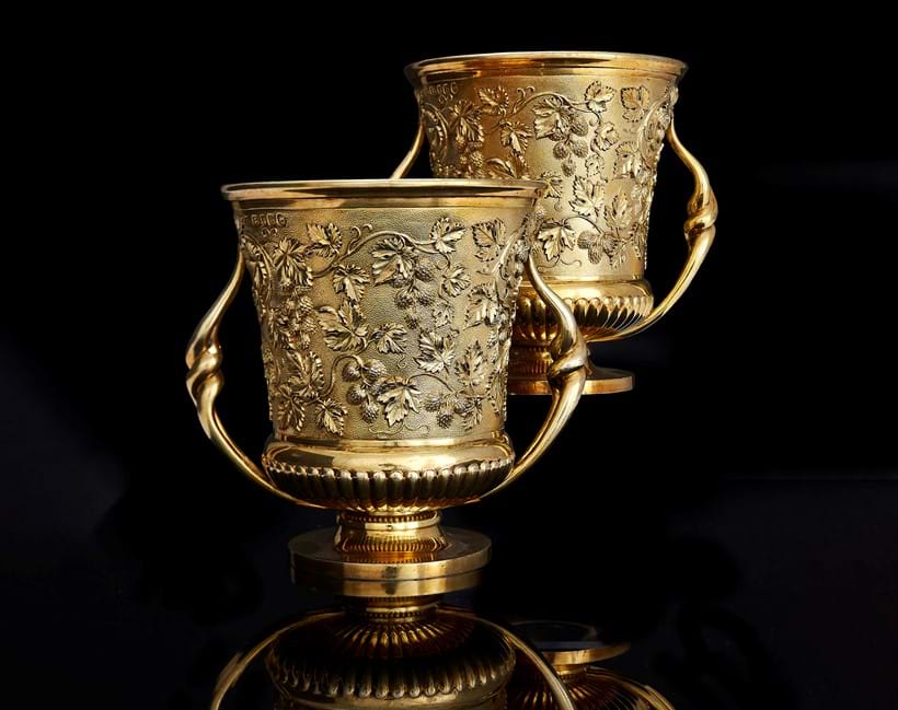 Inline Image - Lot 136: A pair of late George III silver gilt twin handled cups, Paul Storr, London 1817 | Est. £6,000-8,000 (+ fees)