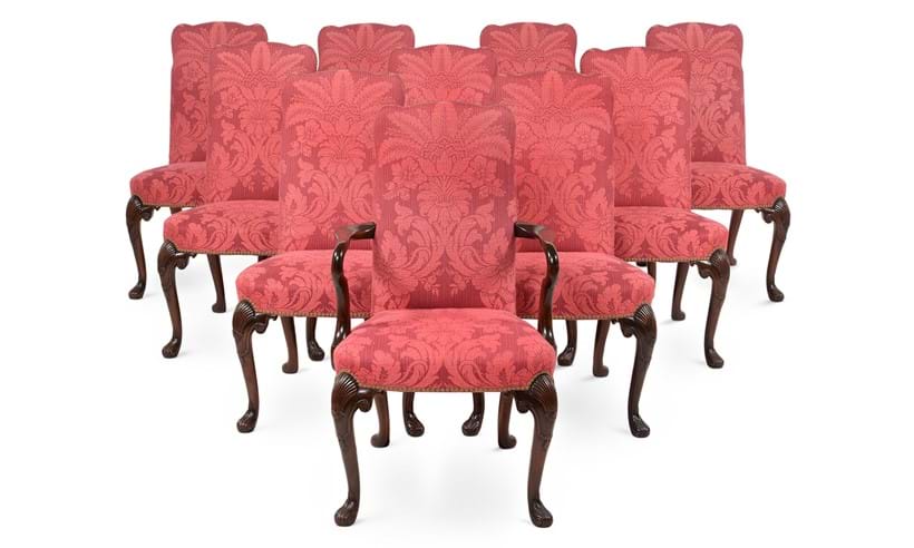 Inline Image - Lot 115: A set of twenty walnut and upholstered dining chairs in George II style, 20th century | Sold for £17,500