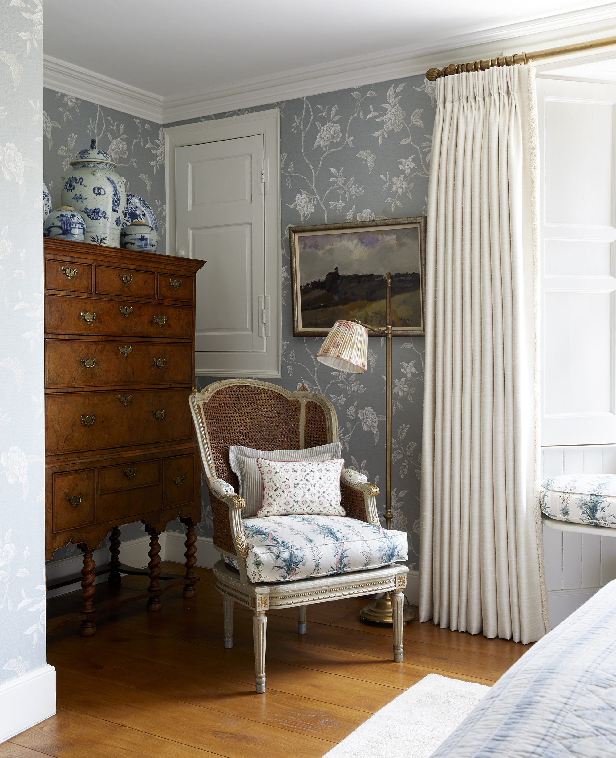 Inline Image - An antique tallboy paired with a French armchair in a bedroom by VSP Interiors