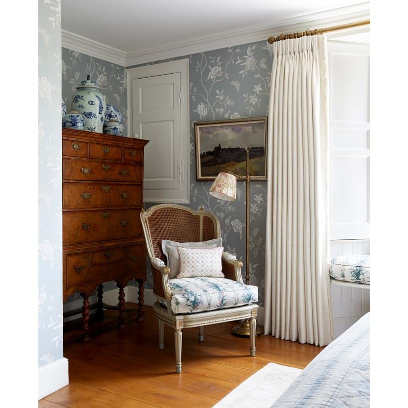 Inline Image - An antique tallboy paired with a French armchair in a bedroom by VSP Interiors