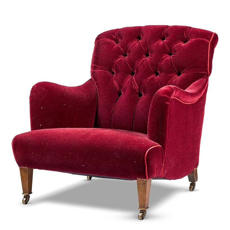 A Howard & Sons red velvet upholstered armchair, circa 1920