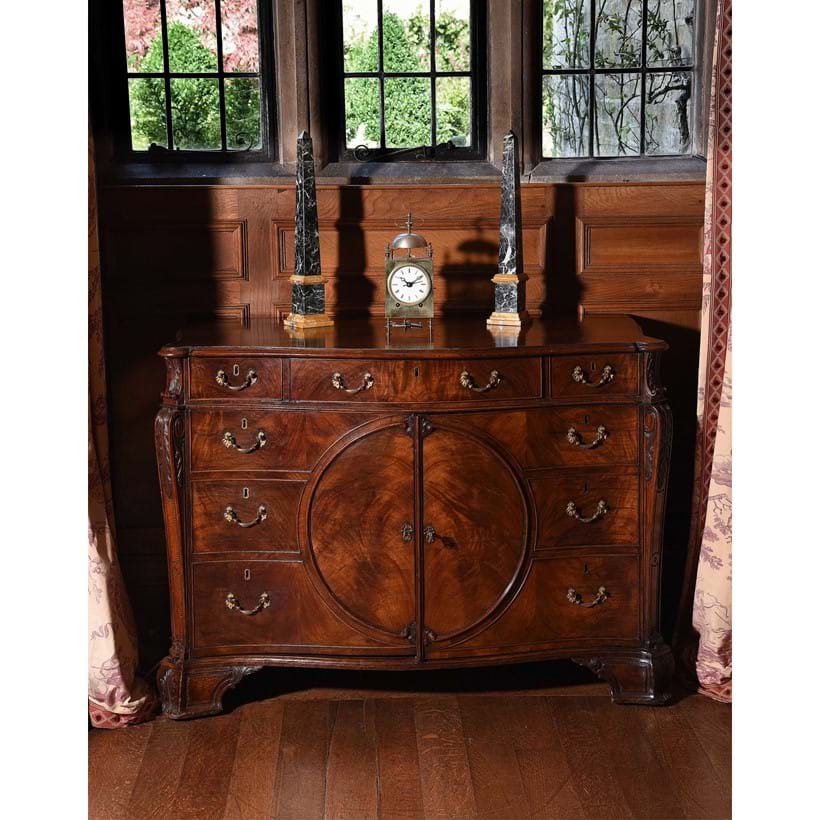 Inline Image - Lot 128: A George III figured mahogany serpentine commode, in the manner of Thomas Chippendale, circa 1770 | Est. £20,000-30,000 (+ fees)