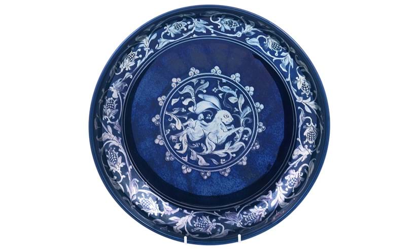 Inline Image - Lot 106: Jonathan Chiswell Jones for JCJ Pottery, a large reduction fired lustre porcelain coupe, fired June 2022, decorated with a running hare, the border with stylised strawberry decoration | Est. £300-400 (+ fees)