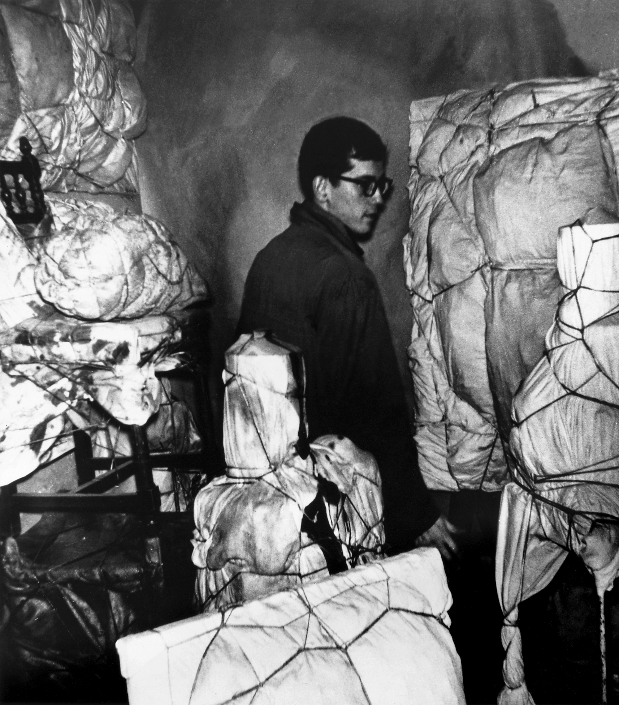 Inline Image - Christo in his seventh floor studio at 14, rue de Saint Sénoch, Paris, November 1961. Property of the Estate of Christo V. Javacheff. Image © Jean-Jacques Lévèque © 1961 Christo and Jeanne-Claude Foundation