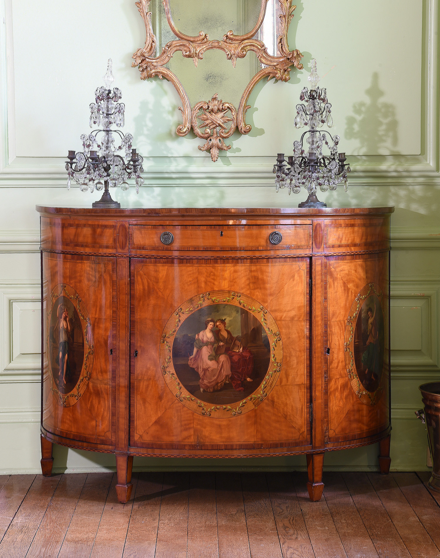 Inline Image - Lot 119: A satinwood and polychrome painted demi-lune commode, in George III style, late 19th century | Est. £1,200-1,800 (+ fees)