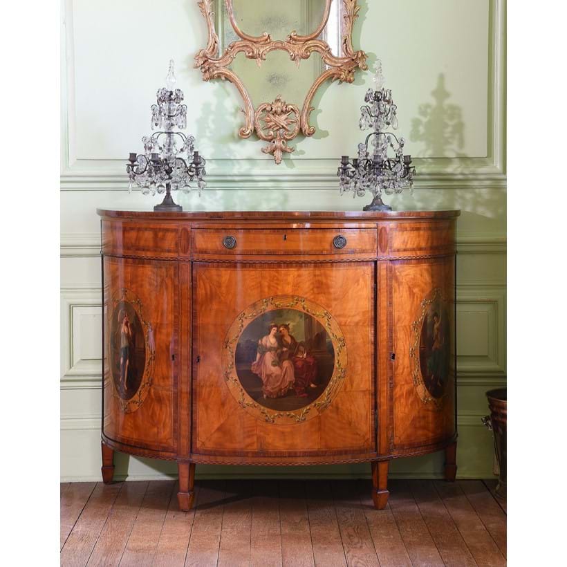 Inline Image - Lot 119: A satinwood and polychrome painted demi-lune commode, in George III style, late 19th century | Est. £1,200-1,800 (+ fees)
