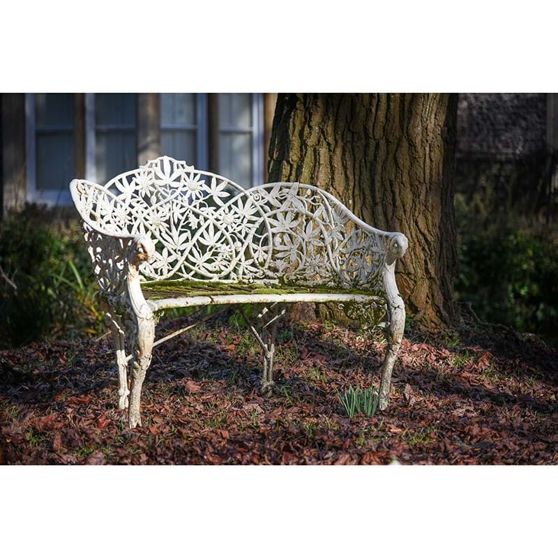 A rare Coalbrookdale white painted cast iron garden seat in the 'passion flower' design