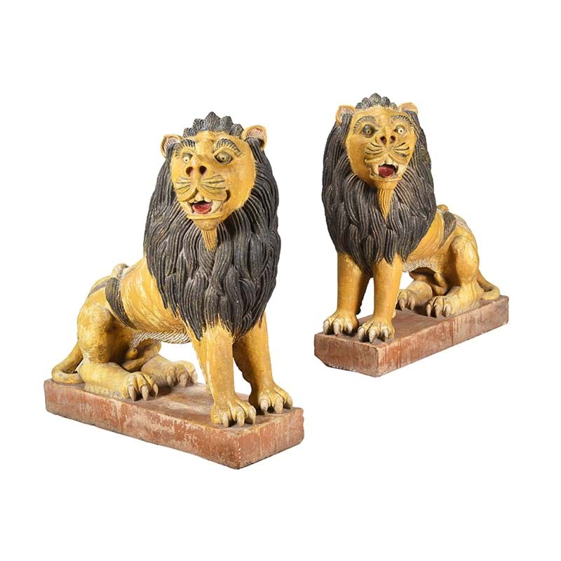 A pair of polychrome painted stoneware lions, 20th century