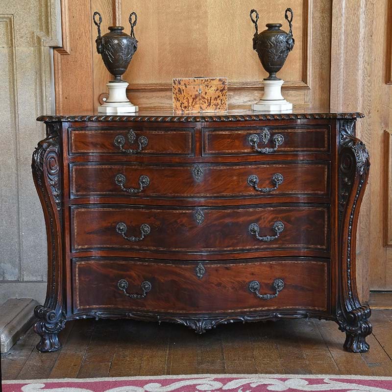 A fine George III mahogany and inlaid serpentine fronted commode, in the manner of William Vile