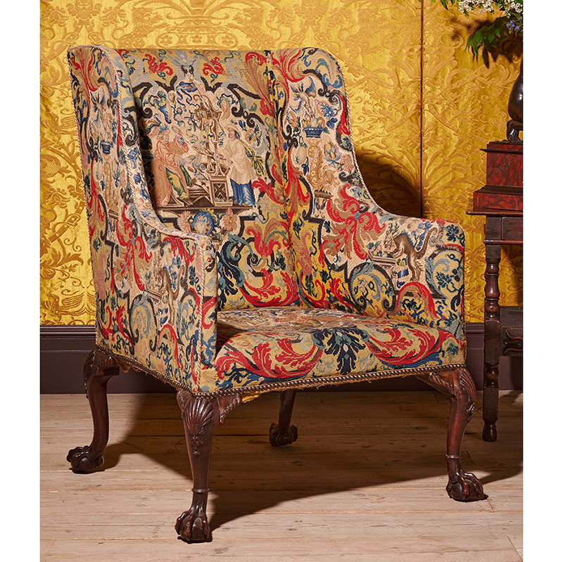 A fine George II carved mahogany and needlework upholstered wing armchair, attributed to William Hallett, circa 1740