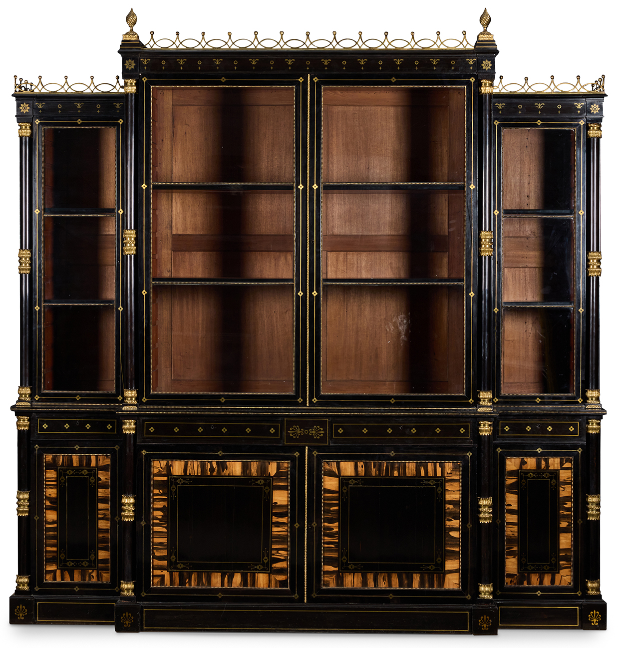 Lot 91 A REGENCY GILT BRASS MOUNTED AND INLAID EBONY AND CALAMANDER BREAKFRONT BOOKCASE